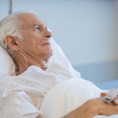 Sad,Senior,Man,Lying,On,Hospital,Bed,And,Looking,Away.