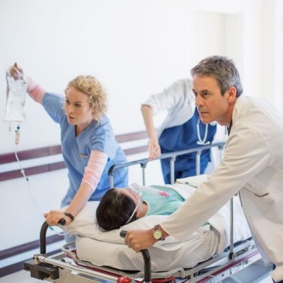 Doctors,And,Nurses,Rushing,Patient,On,Stretcher,Down,Hospital,Corridor